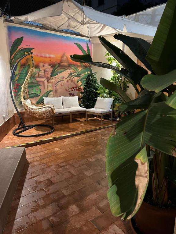 a patio with two white couches and a painting at SPAZIO apARTment di stile METROC 8 stops to COLOSSEO in Rome