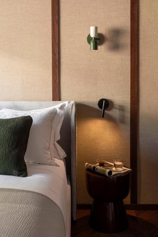 a bedroom with a bed and a nightstand next to a bed at NAMAN HOTELLERIE - Roma in Rome