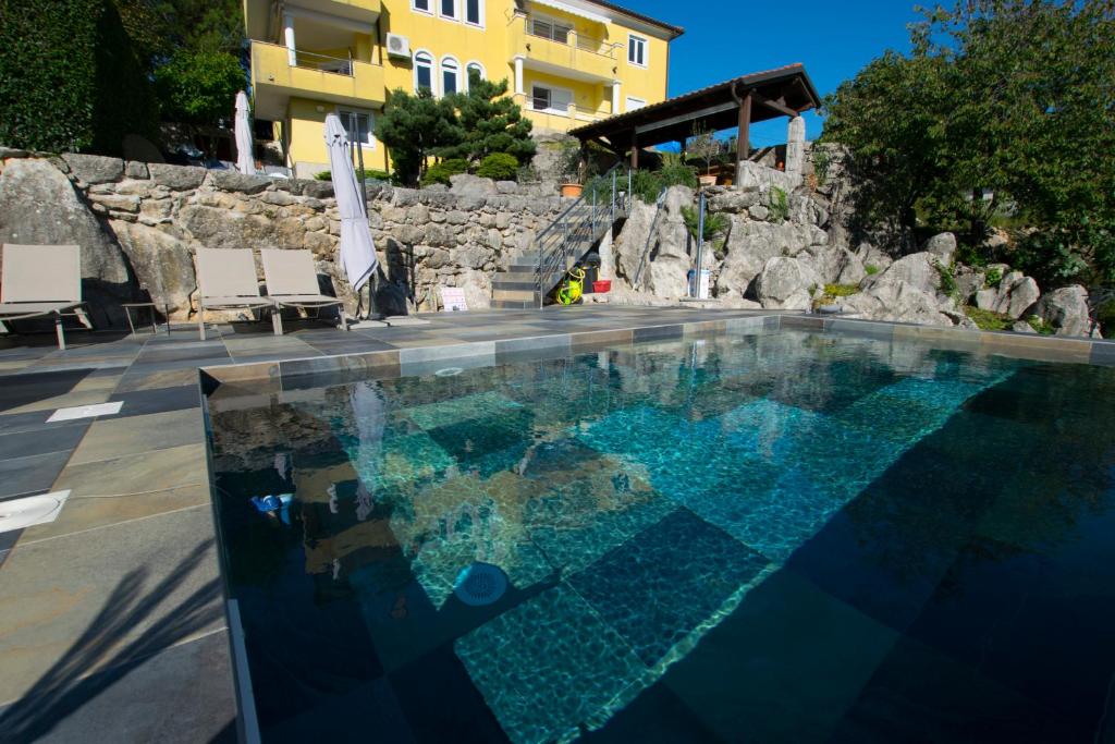 a swimming pool in front of a building at Apartmani BILIC in Kastav