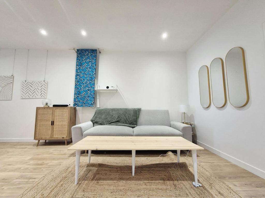 a living room with a couch and a coffee table at La Pause Briochine in Saint-Brieuc