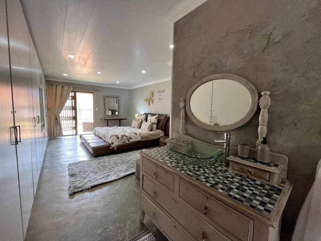 a bedroom with a bed and a large mirror at Lavender Lane in Denysville