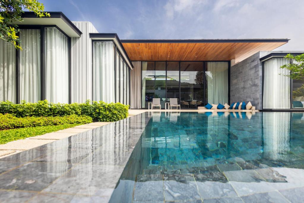 a swimming pool in front of a house at Botanica Foresta B10 in Phuket