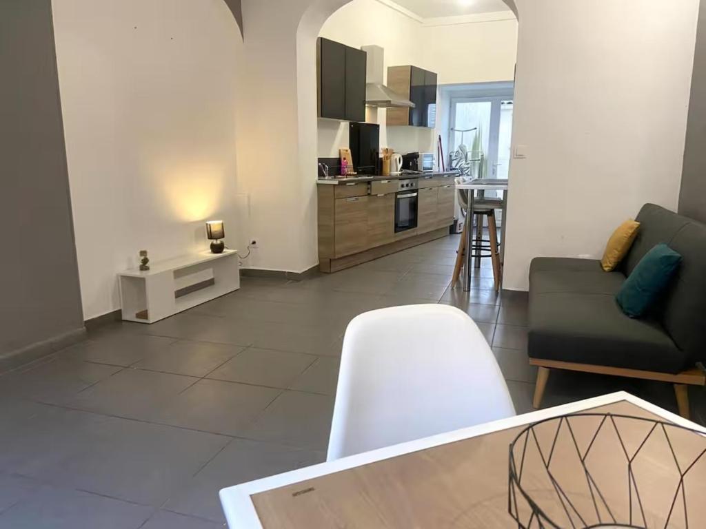 a living room with a couch and a table at ღ Calysta - Studio Proche Centre Ville & Gare in Douai