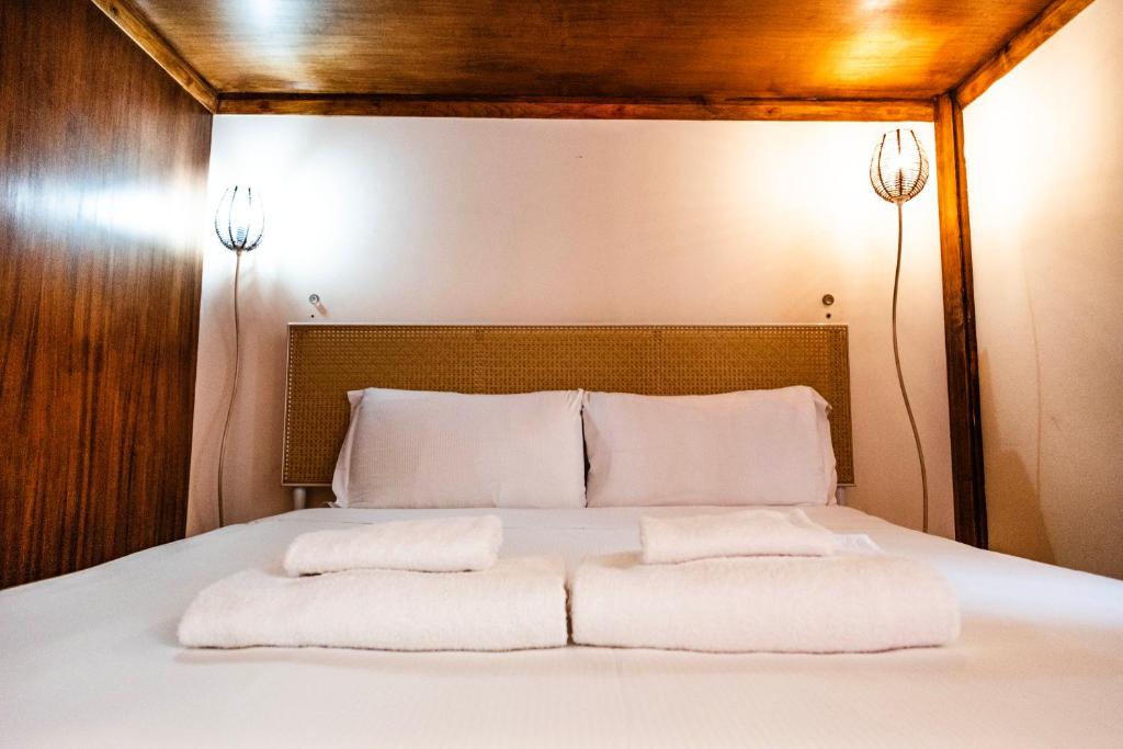 a bed with two white pillows on top of it at La Vite 94 in Rome