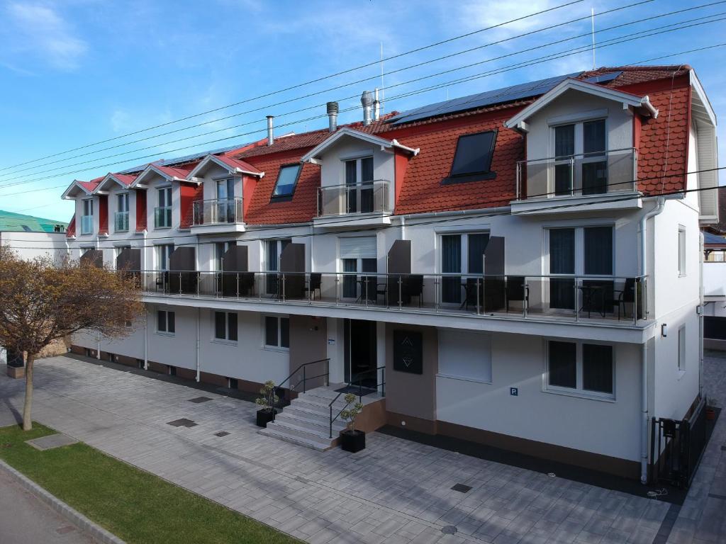 ein großes weißes Gebäude mit vielen Balkonen in der Unterkunft Hotel Crystal in Hajdúszoboszló