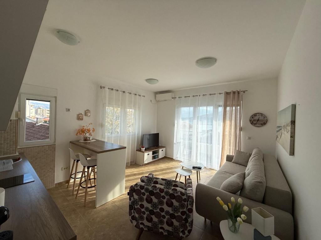 a living room with a couch and a table at BlueCoast Apartment in Herceg-Novi