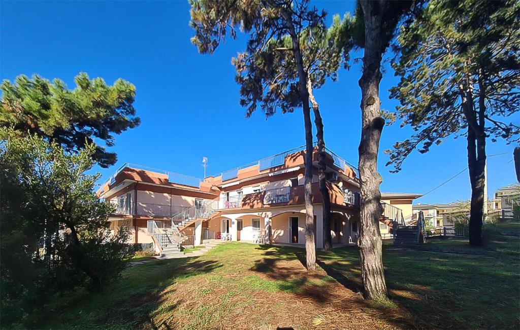 a large house with trees in front of it at Milla 2 in Rosolina Mare
