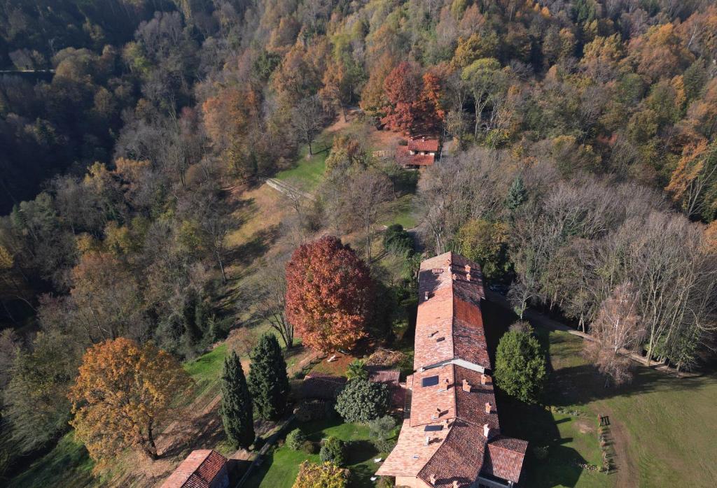 an aerial view of an old brick house in a forest at Il portico sulla valle, Bioglio in Valle San Nicolao