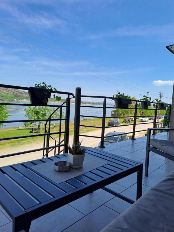a balcony with a bench and a view of the water at std- Na lepom plavom Dunavu in Kladušnica