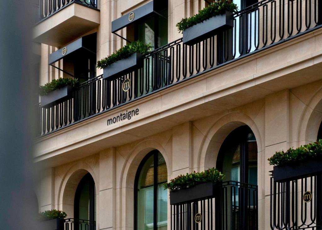 a building with balconies and plants on the side of it at Hotel Montaigne in Ostend
