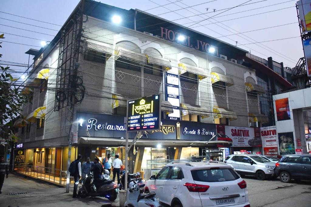 a building with a car parked in front of it at Raj Gharana in Raipur