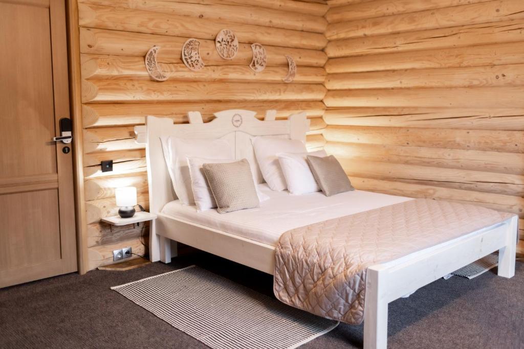 a bedroom with a bed and a wooden wall at LAVANDA hotel club in Slavske