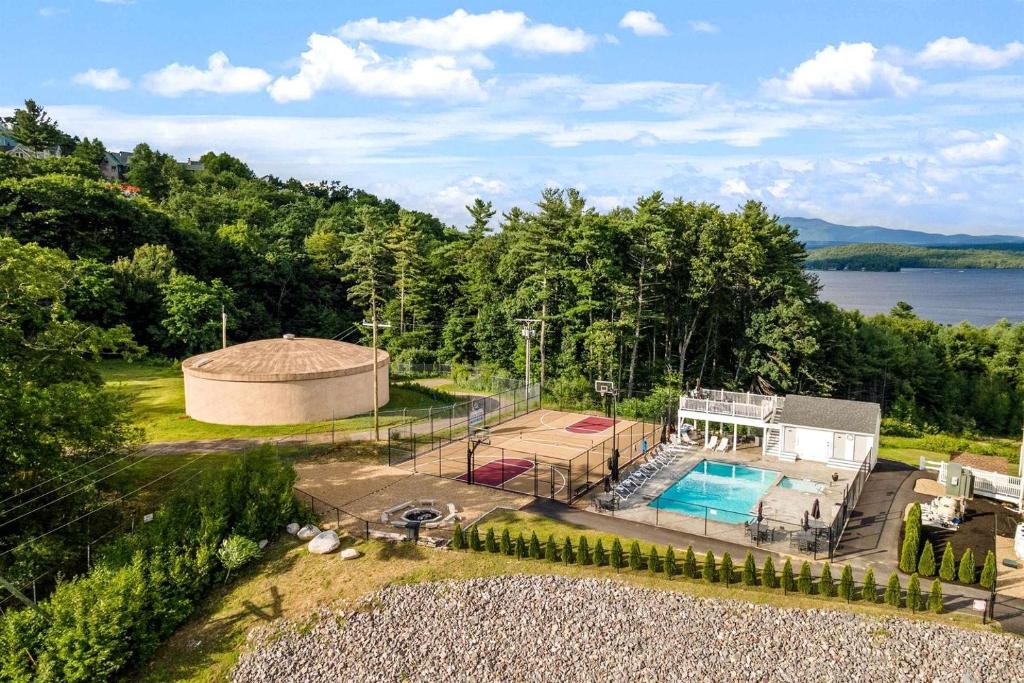 an aerial view of a house with a pool at Relaxing Lakeside Getaway with Stunning Lake Views Near Gunstock | Laconia, NH in Weirs Beach