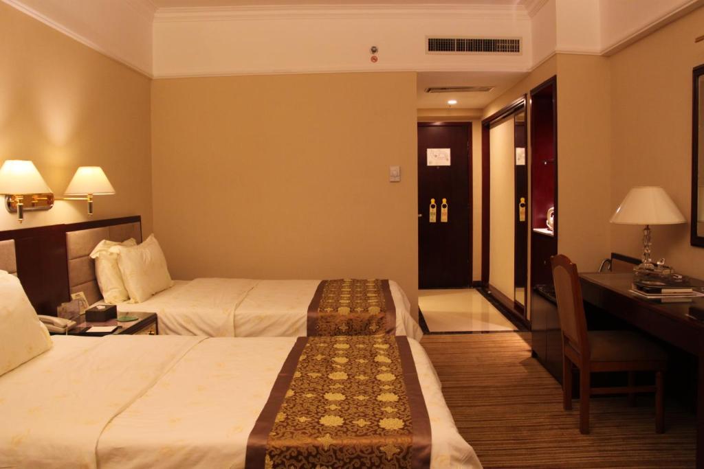 Postel nebo postele na pokoji v ubytování Sunshine Holiday Hotel Fuzhou
