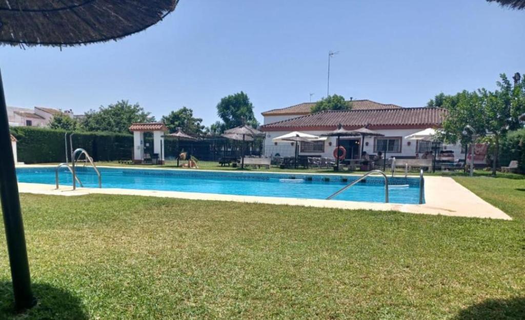 a swimming pool in front of a house at casa andaluza 109 in Novo Sancti Petri