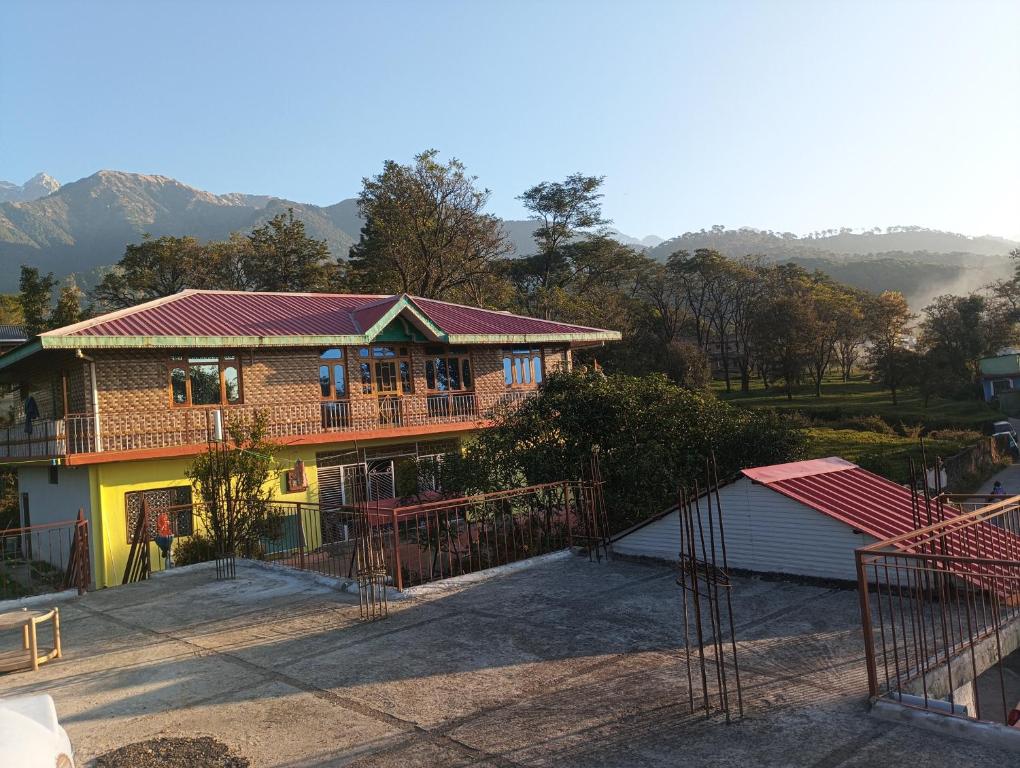 a large house with a porch and a garage at saraswati home stay in Pālampur