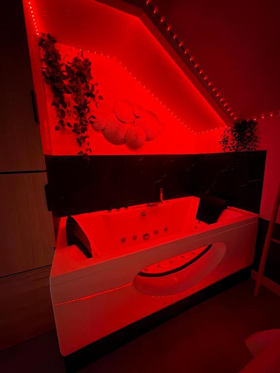 a red bathroom with a sink and a toilet at La Sensuelle Parenthèse in Sète