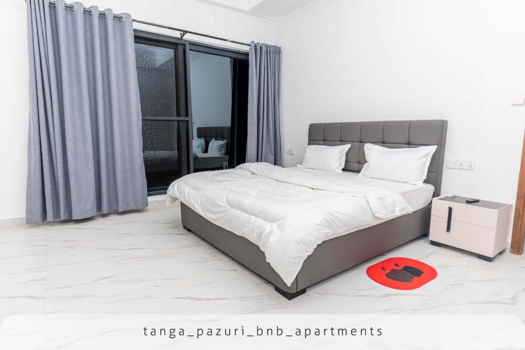 Postel nebo postele na pokoji v ubytování TANGA PAZURI APARTMENTS & BnB's