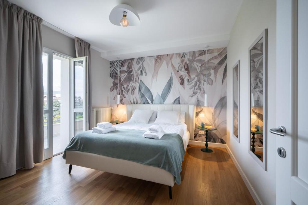 a bedroom with a large bed with a blue blanket at NEW Casa Florentia in Ambrogiana