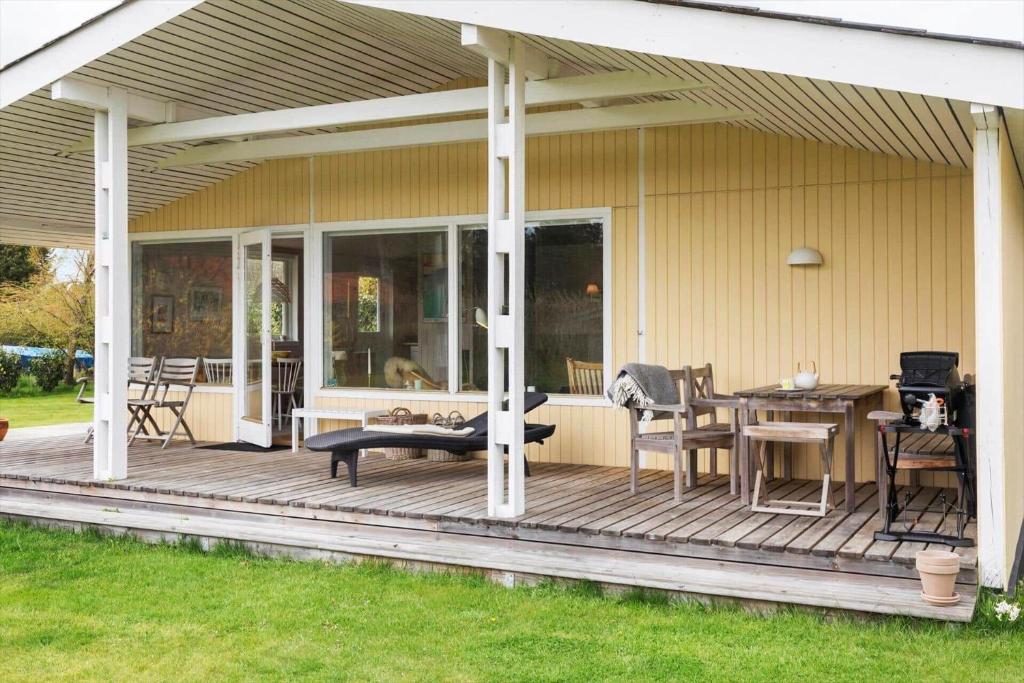 a screened in porch with a table and chairs at 3004-Stege-Paelen-21 in Stege