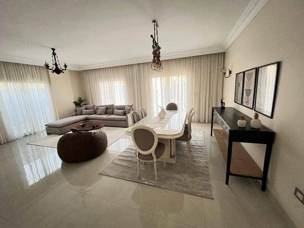 a living room with a table and a couch at Sela 1 in Cairo