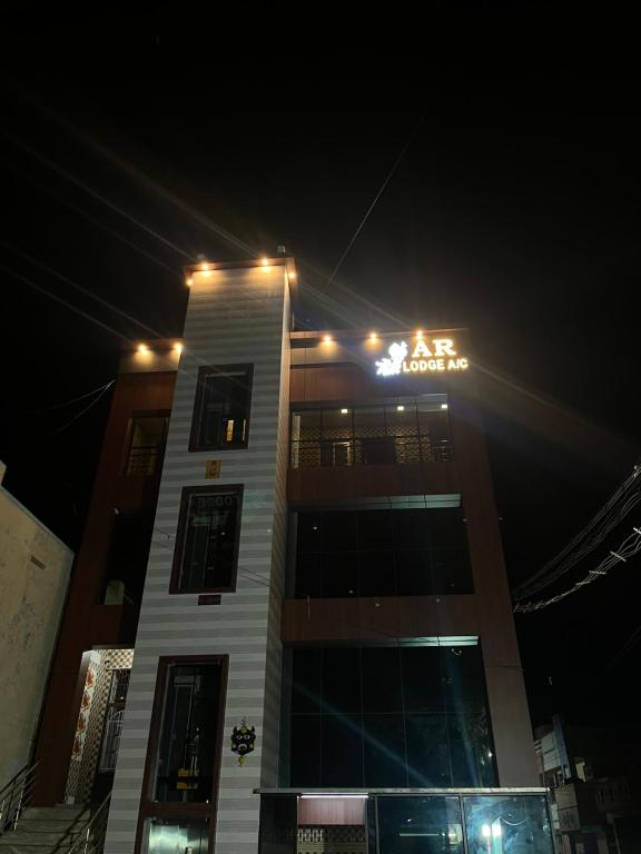 AR lodge في تيروفانمالي: مبنى به أضواء فوقه في الليل