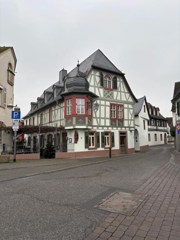 a large building with red and white on a street at Gästehaus Grüner Baum in Oestrich-Winkel