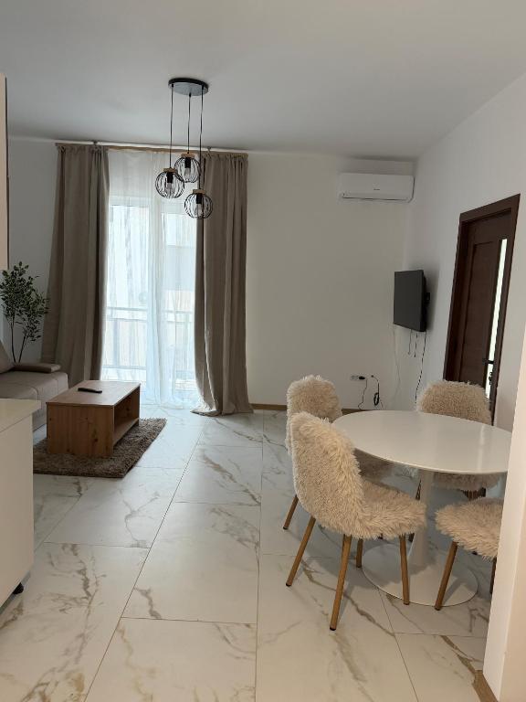 a living room with a table and chairs at Apartament DAR25 in Sînmartin