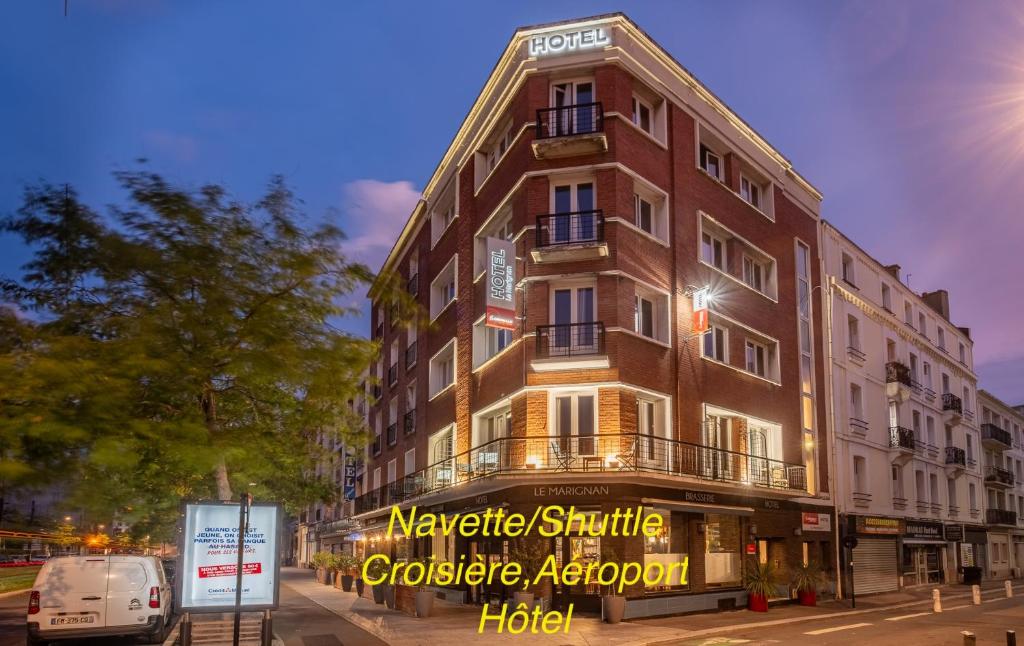 a building with a sign on the side of it at The Originals Boutique, Hôtel Le Marignan,Le Havre Centre Gare in Le Havre