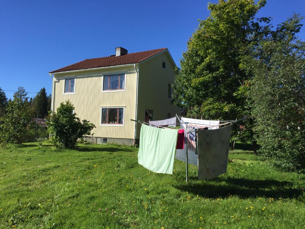 una casa con ropa seca en una línea de ropa en un patio en Villa Insikt Pensionat & Kursgård en Burträsk