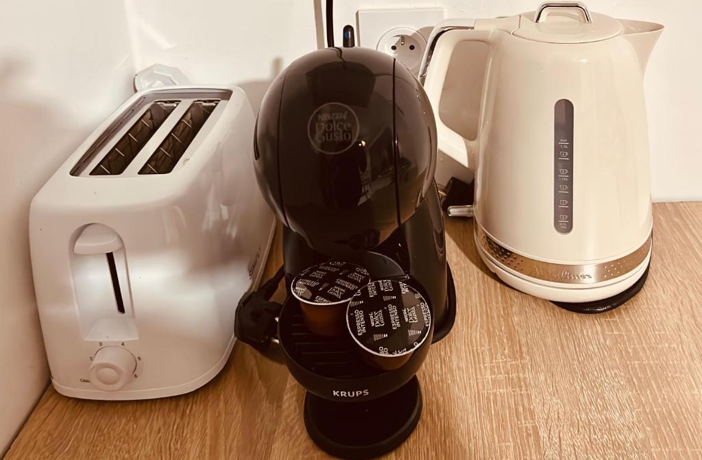 een koffiezetapparaat naast een broodrooster en een blender bij Logement vue mer à 400 m de la plage in Gourbeyre