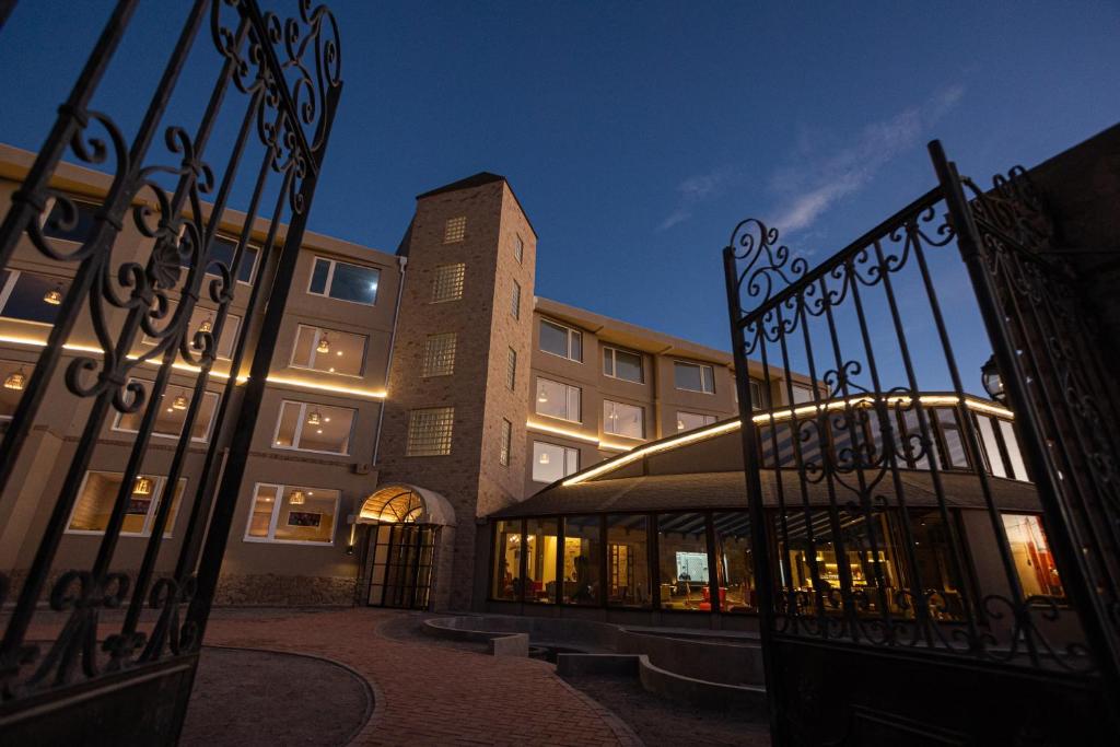 a building with a gate in front of a building at Hotel Rosario Uyuni Collection in Uyuni