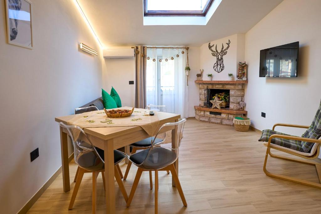 a dining room with a table and chairs and a fireplace at Casa Vacanze Nonna Bambina in Palena