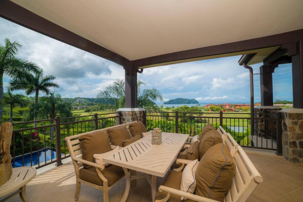 a patio with a table and chairs on a balcony at Vista Bahia 3C - 3bdr 3 bath ocean View in La Mona