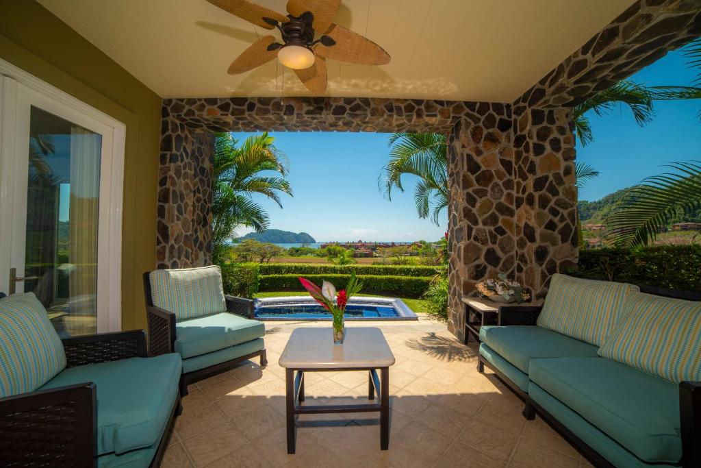 a living room with couches and a table and a ceiling fan at Vista Bahia 3F 1 bedr 1 1 and a half bath ocean view in La Mona
