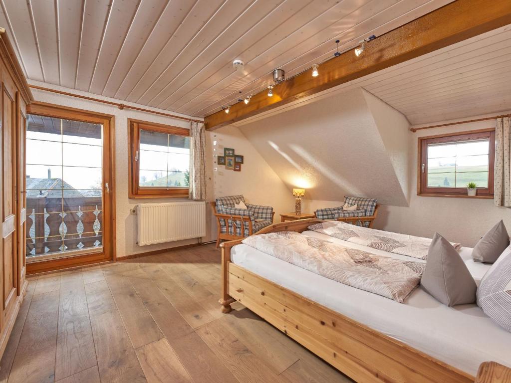 a bedroom with a bed in a room with windows at Kirchlehof in Oberried