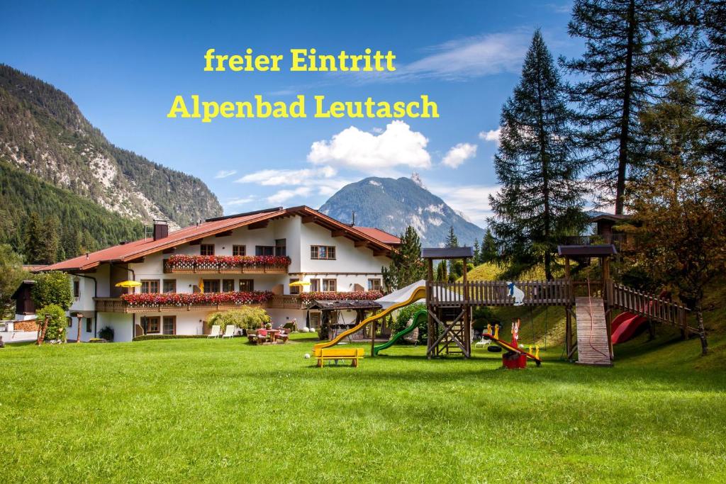 a resort with a playground and a building at Ferienhaus Kirchplatzl in Leutasch