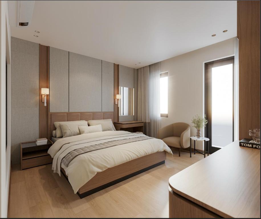 a bedroom with a large bed and a desk at Lam Anh Hotel 9 Him Lam Vạn Phúc in Hà Ðông