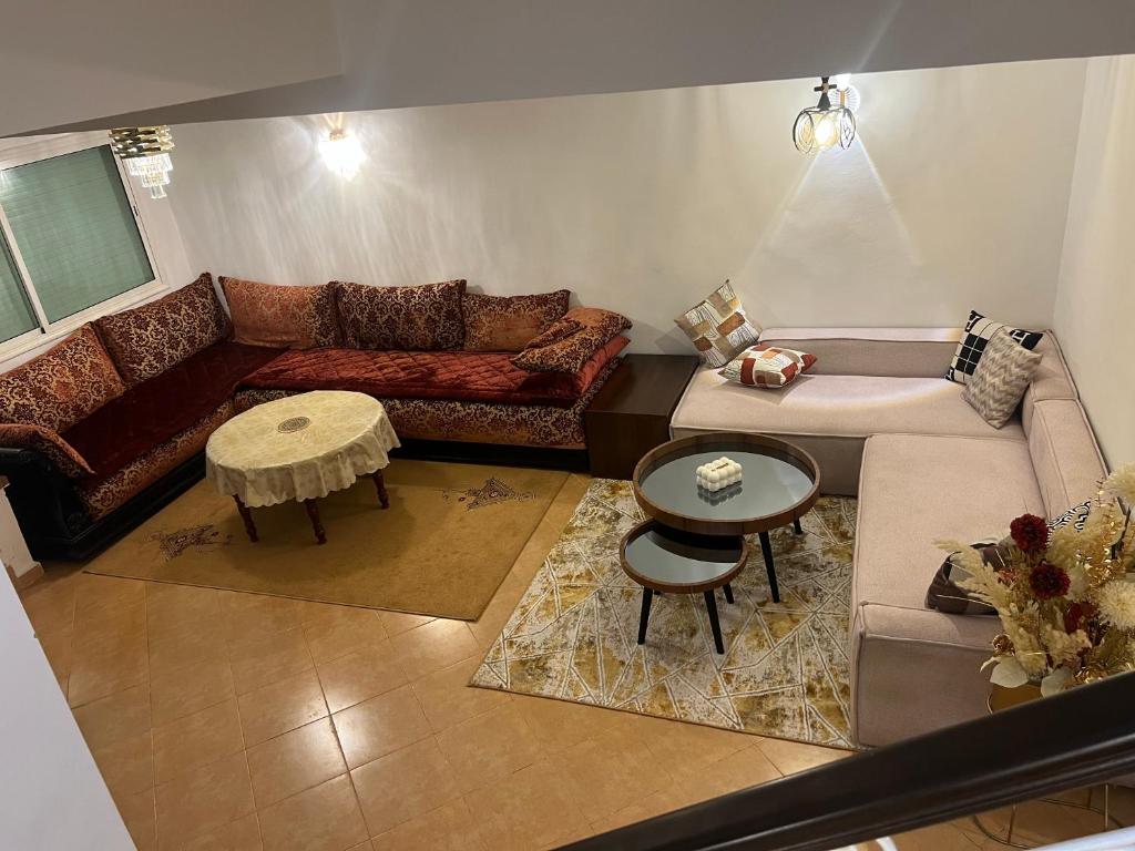 una sala de estar con un sofá y una mesa en Chalet cosy familial à Imouzzer - calme, nature et confort, en Imouzzer Kandar