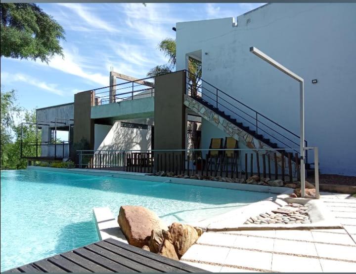 a house with a swimming pool with a balcony at Complejo Eco-Apart SomoS in Colón