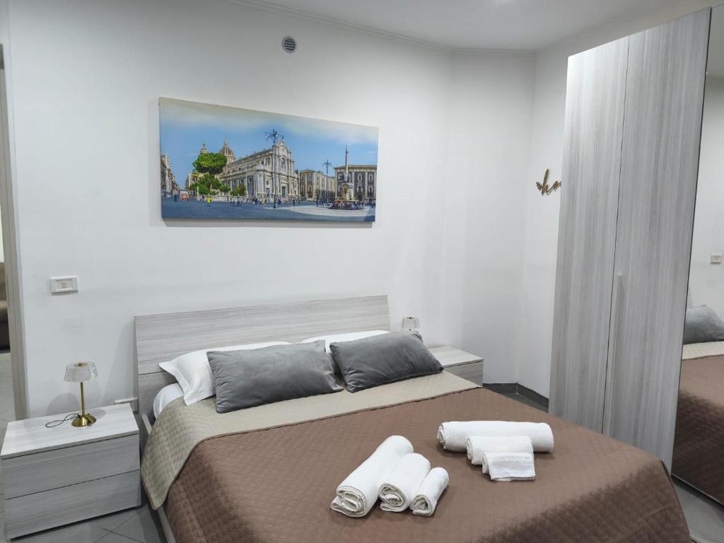 a bedroom with a bed with two towels on it at Garibaldi guest house in Catania