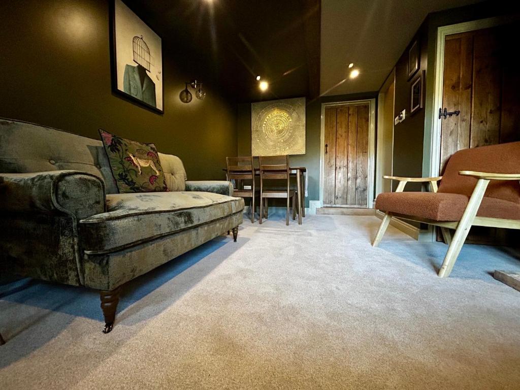 a living room with a couch and a table at Daisy Cottage - Framlingham in Framlingham