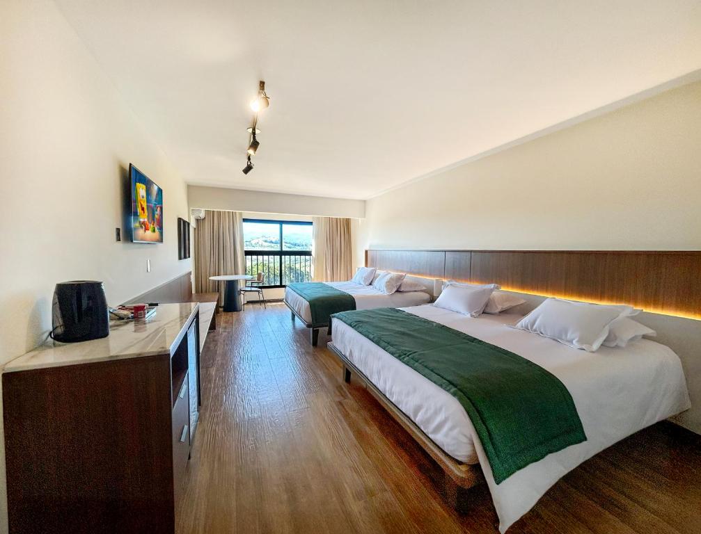 Ένα ή περισσότερα κρεβάτια σε δωμάτιο στο Monreale Resort Parque Aquático