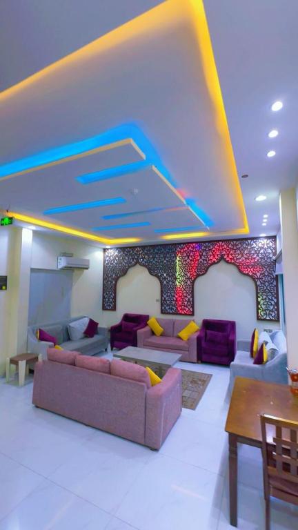 a living room with couches and a colorful wall at منتحع سيتي لاند 3 in Taif
