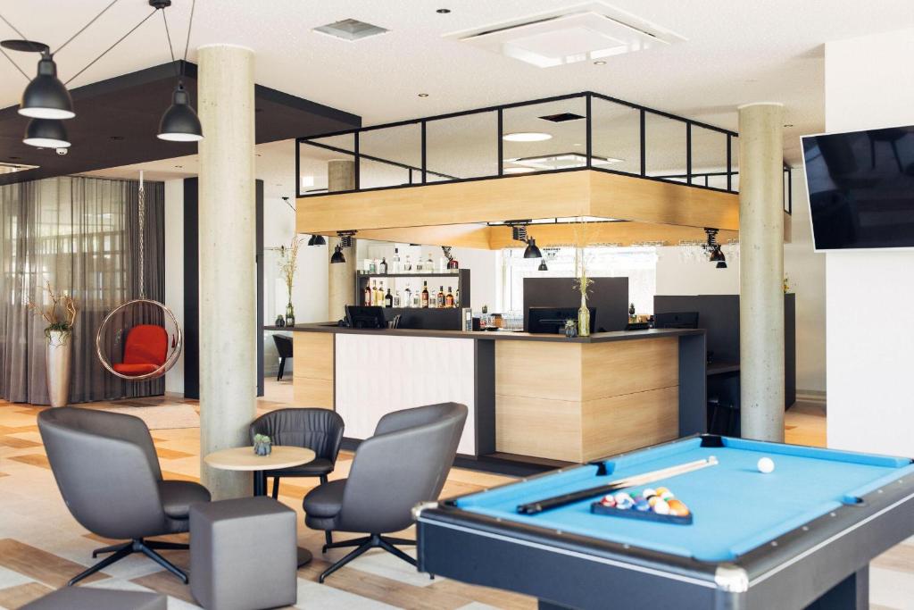 eine Lobby mit Billardtisch und Bar in der Unterkunft harry's home Telfs hotel & apartments in Telfs