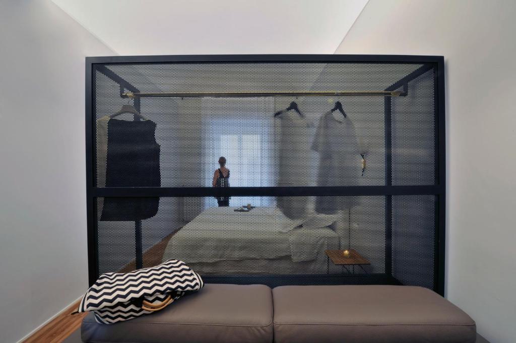 a room with a large glass window with a bed at Lidia Chambres D'hotes in Matera