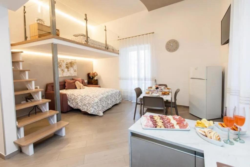 a small room with a bed and a kitchen and a room at Casa Imperati in Agerola