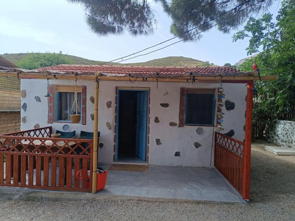 a small house with a gate and a door at The Corsair Cottage in Kalymnos