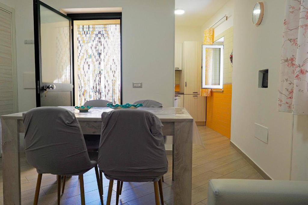 a dining room with a table and two chairs at Well in House Casa Vacanze in Cetara