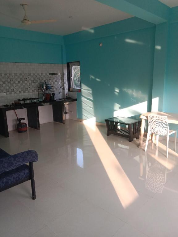 a large living room with a table and chairs at Casa De D'souza in Mandrem